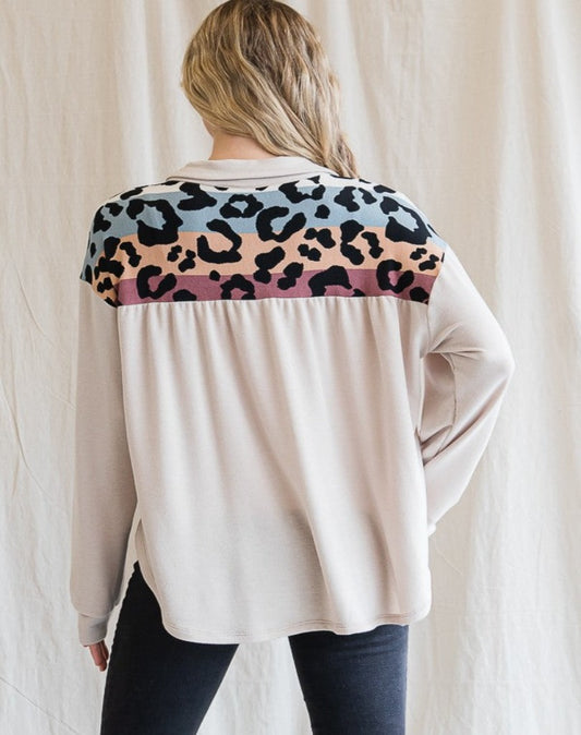 Back view. Cream colored button up shacket with multicolor animal print detail.